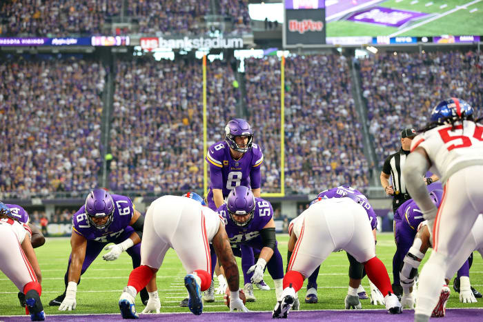 Minnesota Vikings center Garrett Bradbury prepares to snap the ball to quarterback Kirk Cousins, standing behind him, as Giants players line up opposite